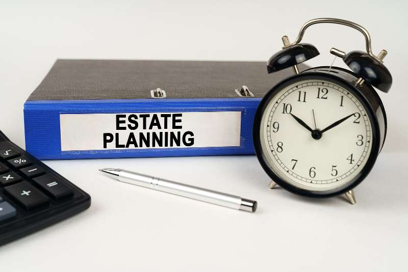 Financial Planning image with binder and alarm clock