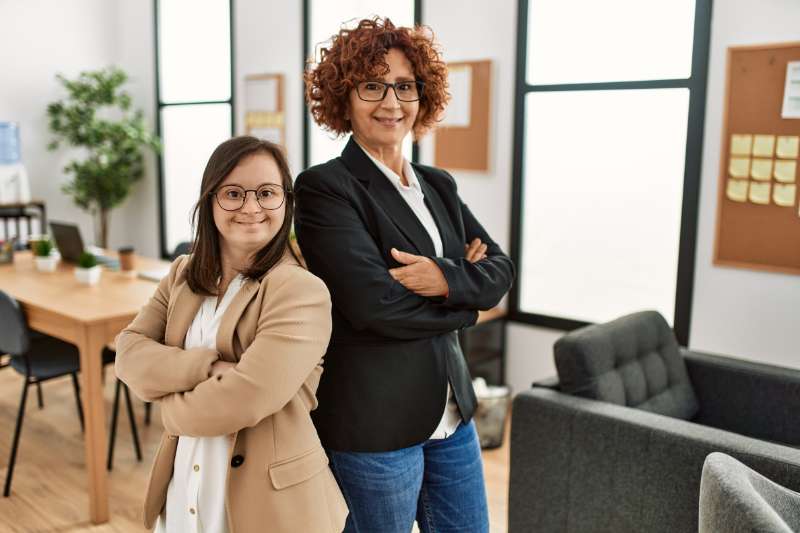 Couple of women standing in office