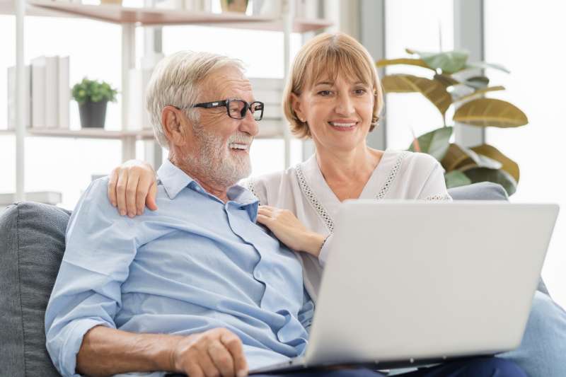 senior couple looking at laptop computer