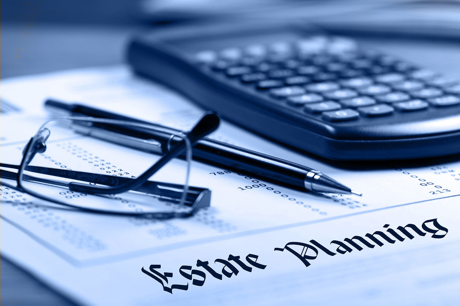 Estate planning. Calculator, glasses and black pen on financial documents